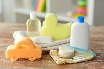 Image showing baby accessories for bathing on wooden table