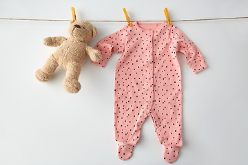 Image showing bodysuit for baby girl hanging on rope with teddy