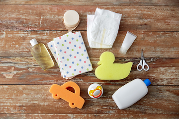 Image showing baby accessories for bathing on wooden table