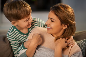 Image showing happy smiling mother and son hugging at home