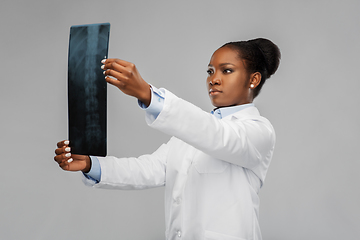 Image showing african american female doctor looking at x-ray