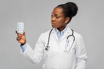 Image showing african american female doctor with medicine pills