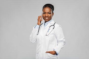 Image showing african female doctor calling on smartphone