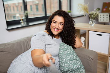 Image showing happy woman taking selfie at home