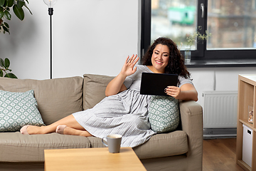 Image showing woman with tablet pc having video chat at home