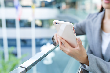 Image showing Businesswoman sending sms on cellphone