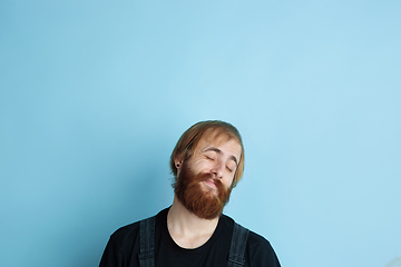 Image showing Portrait of young caucasian man looks dreamful and happy