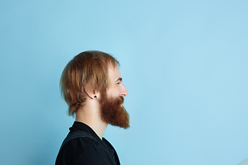 Image showing Portrait of young caucasian man looks dreamful and happy