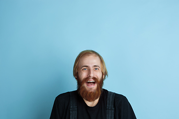 Image showing Portrait of young caucasian man looks dreamful and happy