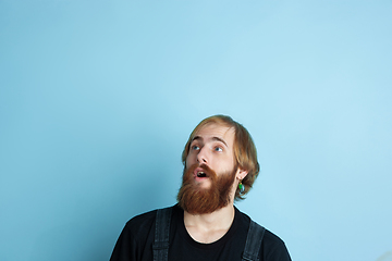 Image showing Portrait of young caucasian man looks dreamful and happy