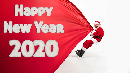 Image showing Santa Claus wishing happy New Year and Merry Christmas