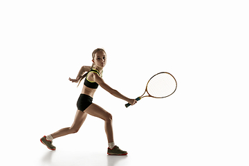 Image showing Little caucasian girl playing tennis isolated on white background