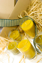 Image showing yellow candles, ribbon and box