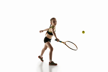 Image showing Little caucasian girl playing tennis isolated on white background