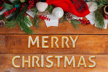 Image showing New Year wishes made of cakes on wooden table background