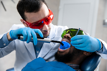 Image showing Young african-american man visiting dentist\'s office