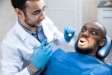 Image showing Young african-american man visiting dentist\'s office