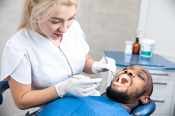 Image showing Young african-american man visiting dentist\'s office