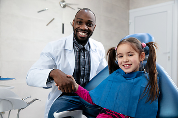 Image showing Young caucasian girl visiting dentist\'s office, smiling