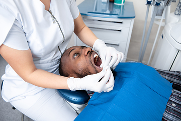 Image showing Young african-american man visiting dentist\'s office