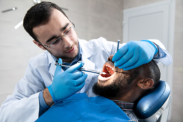 Image showing Young african-american man visiting dentist\'s office