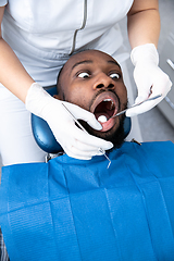 Image showing Young african-american man visiting dentist\'s office