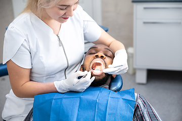 Image showing Young african-american man visiting dentist\'s office