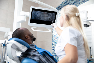 Image showing Young african-american man visiting dentist\'s office