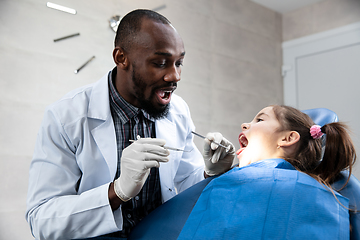 Image showing Young caucasian girl visiting dentist\'s office