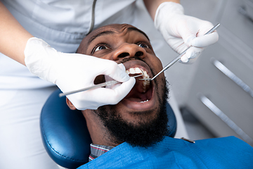 Image showing Young african-american man visiting dentist\'s office