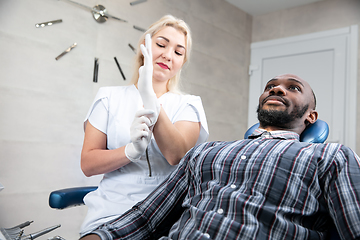 Image showing Young african-american man visiting dentist\'s office