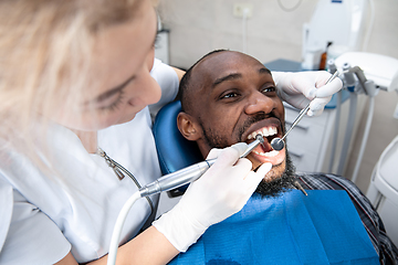 Image showing Young african-american man visiting dentist\'s office, smiling