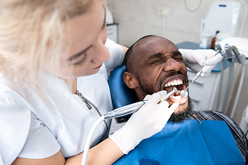 Image showing Young african-american man visiting dentist\'s office