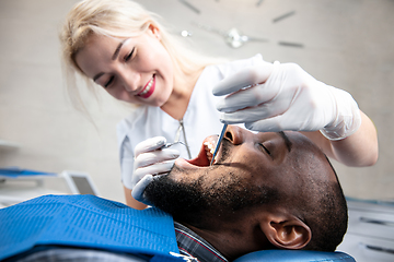 Image showing Young african-american man visiting dentist\'s office