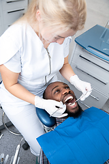 Image showing Young african-american man visiting dentist\'s office