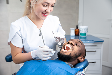 Image showing Young african-american man visiting dentist\'s office