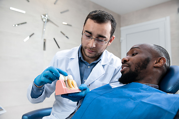 Image showing Young african-american man visiting dentist\'s office