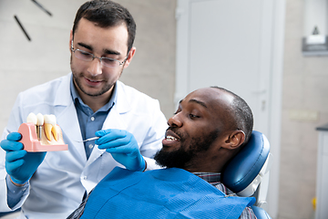 Image showing Young african-american man visiting dentist\'s office