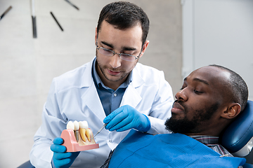 Image showing Young african-american man visiting dentist\'s office