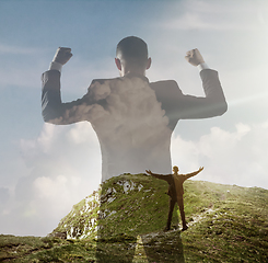 Image showing Silhouette of businessman with landscapes on background, double exposure.