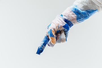 Image showing Big plastic hand made of garbage isolated on white studio background