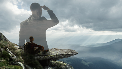 Image showing Silhouette of businessman with landscapes on background, double exposure.