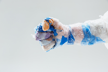 Image showing Big plastic hand made of garbage isolated on white studio background