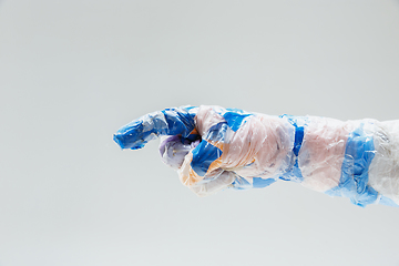 Image showing Big plastic hand made of garbage isolated on white studio background