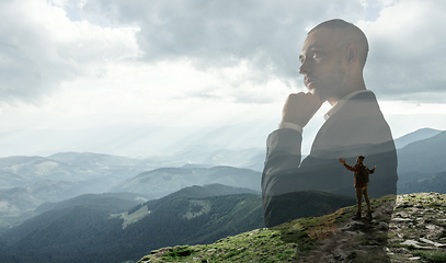 Image showing Silhouette of businessman with landscapes on background, double exposure.