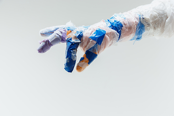 Image showing Big plastic hand made of garbage isolated on white studio background