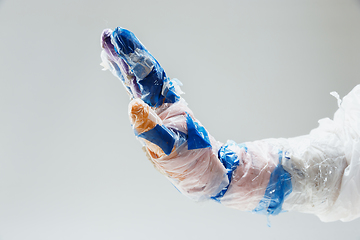 Image showing Big plastic hand made of garbage isolated on white studio background