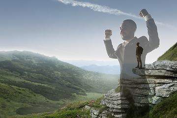 Image showing Silhouette of businessman with landscapes on background, double exposure.