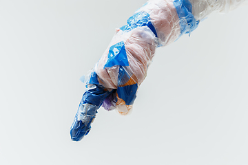 Image showing Big plastic hand made of garbage isolated on white studio background