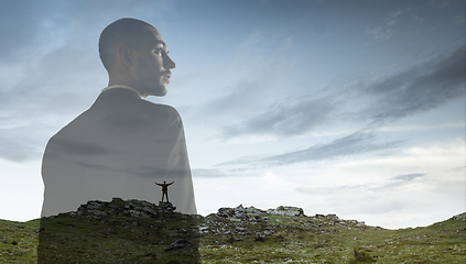 Image showing Silhouette of businessman with landscapes on background, double exposure.